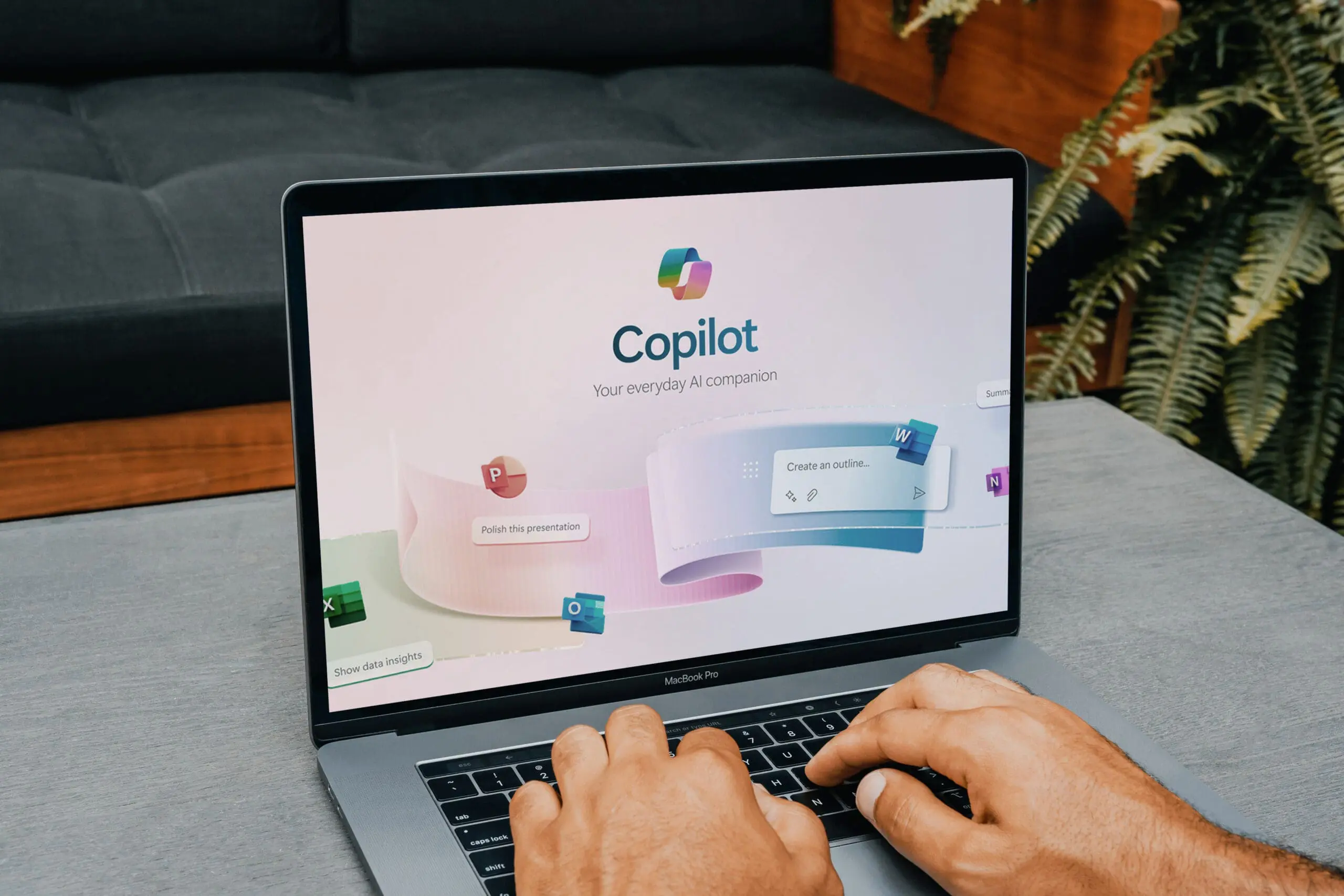 Office worker using copilot, microsoft’s new ai companion, on a macbook pro